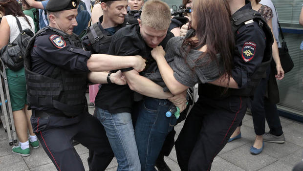 Police officers detain gay rights activists as they gathered near the State Duma, Russia's lower parliament chamber, in Moscow, Russia, on June 11, 2013.  AP PHOTO/IVAN SEKRETAREV