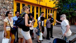 Jim Power talks to a group of tourists on Avenue A in the East Village.