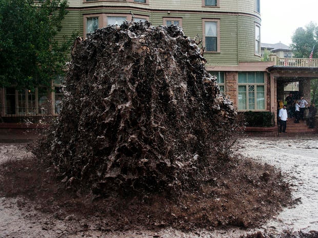 Flood water shoots out of a sewer next to the Cliff House in Manitou Springs, Colo., Sept. 12, 2013.