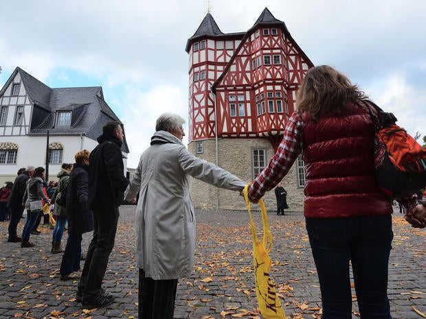 Protestors form a human chain from the the cathedral to the new residence of the Bishop of Limburg