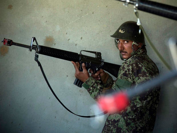 Afghan army soldiers get house-to-house search instructions at a training facility in the outskirts of Kabul