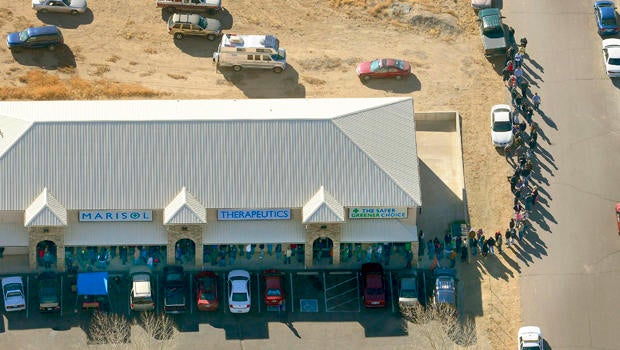 A long line of buyers trails from a store selling marijuana in Pueblo West, Colo., Jan. 1, 2014.