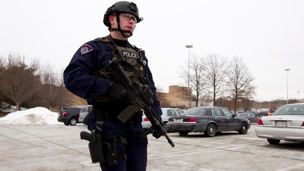 Police move in from a parking lot to the Mall in Columbia after a multiple shooting Jan. 25, 2014, in Howard County, Md.