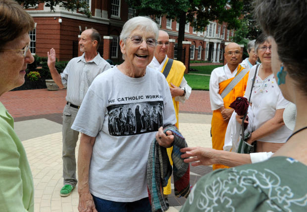 Sister Megan Rice, center, and Michael Walli, in the background waving, are greeted by supporters as they arrive for a federal court appearance in Knoxville, Tenn., Aug. 9, 2012. 