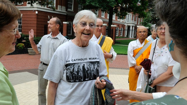 Sister Megan Rice, center, and Michael Walli, in the background waving, are greeted by supporters as they arrive for a federal court appearance in Knoxville, Tenn., Aug. 9, 2012. 