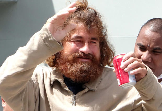 A castaway from Mexico who identified himself as Jose Salvador Alvarenga walks with the help of a Majuro Hospital nurse in Majuro