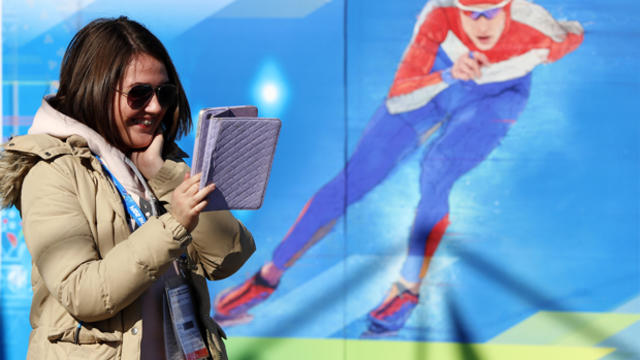 A woman speaks to somebody via a tablet computer ahead of the team welcome ceremony Feb. 6, 2014, prior to the start of the 2014 Sochi Winter Olympic Games. 