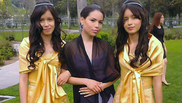 Twin sisters Marisol Serrato, 17, left, and Marisa Serrato, right, with their sister-in-law, Ivette Serrato, are seen during a wedding in Riverside, Calif., in this 2013 photo provided by Miguel Serrato. 