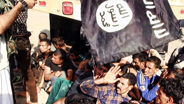 This image posted on a militant website June 14, 2014, which has been verified appears to show militants from the al-Qaeda-inspired Islamic State of Iraq and Syria (ISIS) with captured Iraqi soldiers wearing plain clothes after taking over a base in Tikri