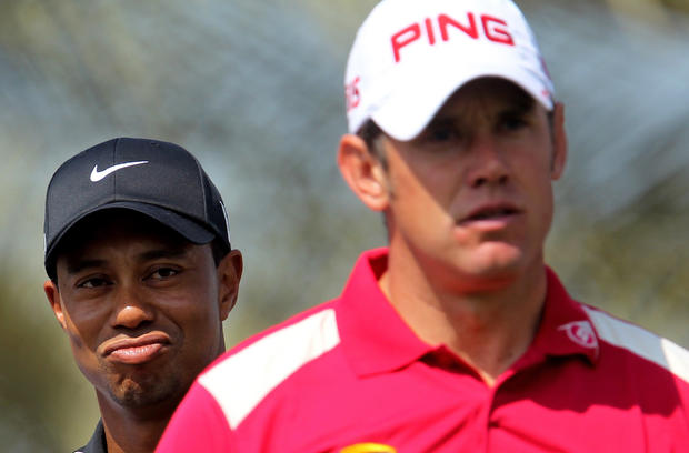 US golfer Tiger Woods (L) grimaces as he 