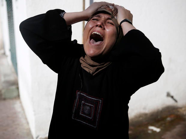 The mother of one of the four Palestinian children from the Baker family grieves outside the morgue in Gaza City July 16, 2014.