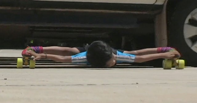 "Limboskating" world record 6yearold passes under 39 cars on roller