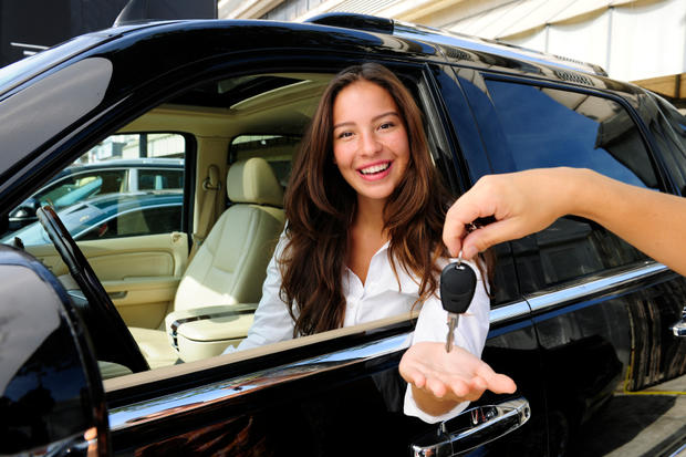 businesswoman receiving keys of her new off-road car car rental 