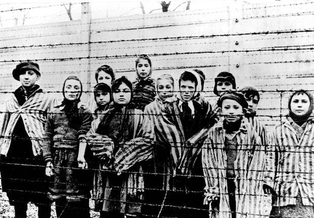This picture, taken just after the liberation of Auschwitz by the Soviet army in January 1945, shows a group of children wearing concentration camp uniforms.  (Credit: Associated Press)