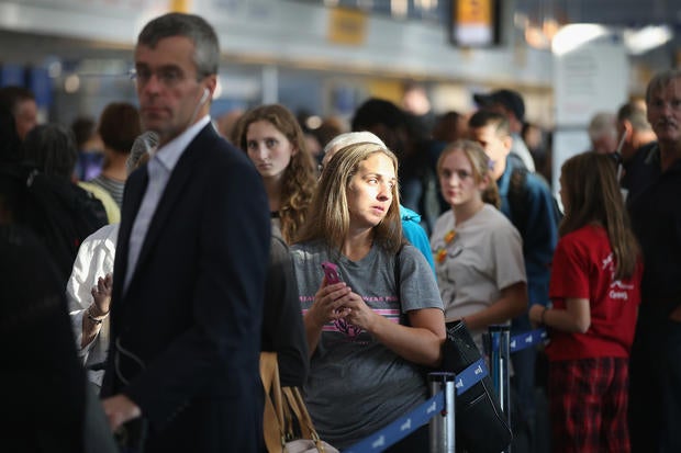 Passengers wait in line to check in for flights at O'Hare International Airport in Chicago, Illinois, Sept. 26, 2014.