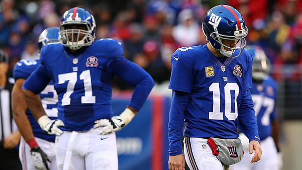 Charles Brown #71 and Eli Manning #10 of the New York Giants 
