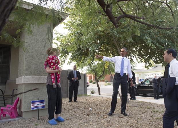 US President Barack Obama greets an area resident during a neighborhood stop to highlight his administration's home purchase and refinancing policies in Phoenix, Arizona, January 8, 2015.