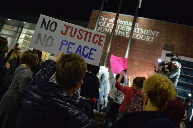 Demonstrators outside Ferguson, Missouri Police Department on March 11, 2015 after announcement that city's embattled police chief was resigning 