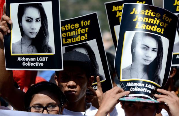 Supporters of the late Jennifer Laude hold up her image during a protest near a Philippine court in Olongapo, north of Manila