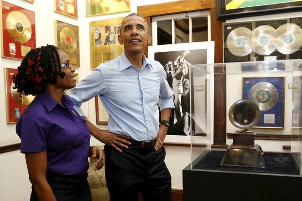 President Obama gets a tour of the Bob Marley Museum from a staff member Natasha Clark in Kingston, Jamaica