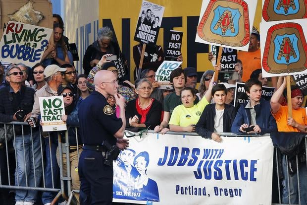 Protesters, many against the so-called fast track trade authority of the Trans-Pacific Partnership (TPP) trade agreement, rally outside the hotel where President Obama is participating in a Democratic National Committee (DNC) event
