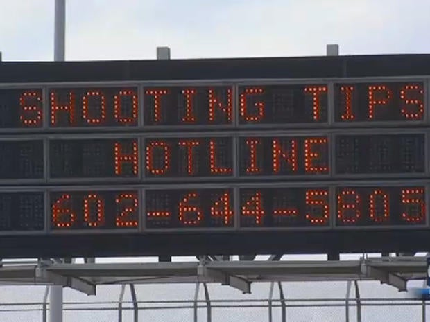 Highway sign is seen in Phoenix on September 9, 2015 uring people to call in tips as authorities pressed their investigation into a series of incidents on city highways in which windows of passing vehicles were shot out