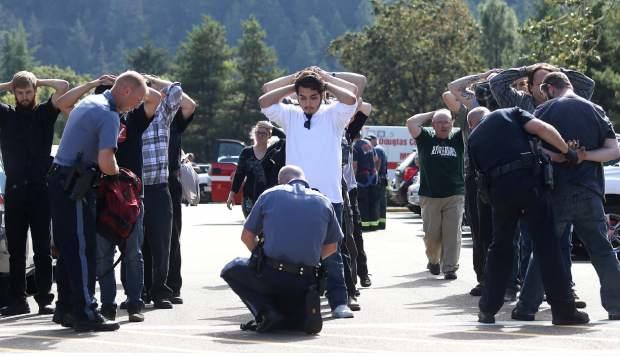 Authorities check bags as students and staff are moved off campus at Umpqua Community College after a shooting Oct. 1, 2015.