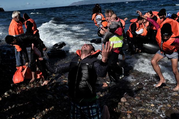 A man reacts as he arrives with other refugees and migrants on the Greek island of Lesbos