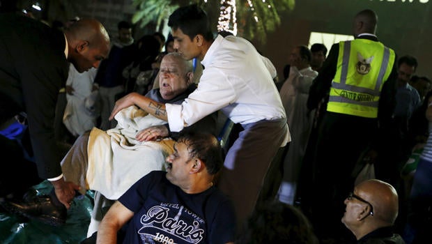Wounded people are seen outside the Address Downtown Dubai hotel and residential block after a fire engulfed the skyscraper in downtown Dubai in the United Arab Emirates Dec. 31, 2015.