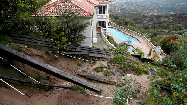 A home with a fence destroyed by a mudslide is seen after an El Nino-strengthened storm brought rain to Pasadena, California, Jan. 6, 2016.