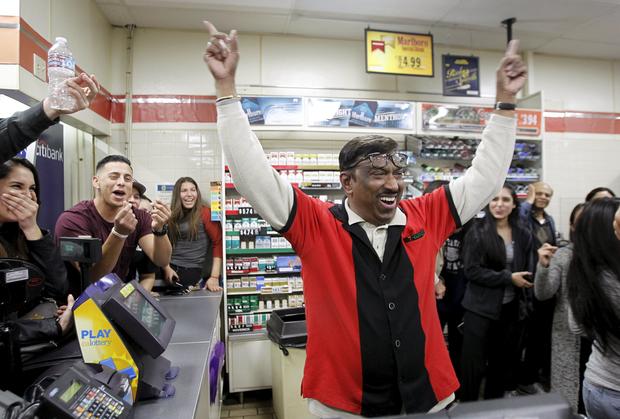 7-Eleven store clerk M. Faroqui celebrates after learning winning Powerball ticket was sold in store where he works in Chino Hills, California, on January 13, 2016