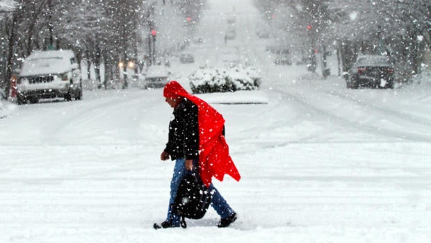 A man walks through heavy snow in downtown Nashville, Tenn., Jan. 22, 2016. Much of downtown was deserted as state and city government offices were closed for the day.