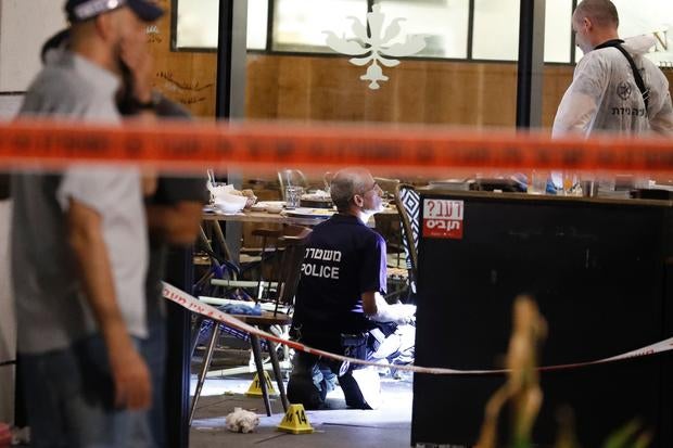 Israeli forensic police inspect restaurant following terror attack in Tel Aviv market on June 8, 2016