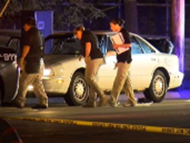 Investigators from the Minnesota Bureau of Criminal Apprehension inspect a car in which a passenger was fatally shot by a police officer during a traffic stop in the St. Paul suburb of Falcon Heights on July 6, 2016.