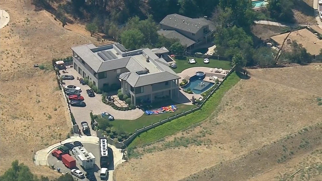 Chris Brown peacefully emerges from home after police serve warrant