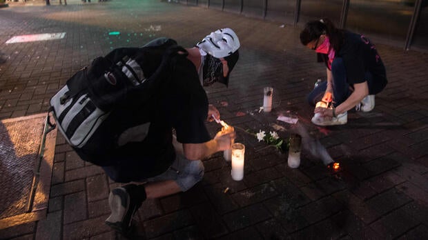 Protesters light candles on Sept. 22, 2016, at the site where Justin Carr was shot on Sept. 21, 2016, during a demonstration against police brutality in Charlotte, North Carolina, following the shooting of Keith Lamont Scott by police two days earlier and