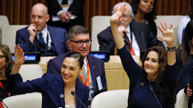 Actors Gal Gadot and Lynda Carter wave during an event to name Wonder Woman the U.N. honorary ambassador for the empowerment of women and girls at the United Nations headquarters in the Manhattan borough of New York Oct. 21, 2016.