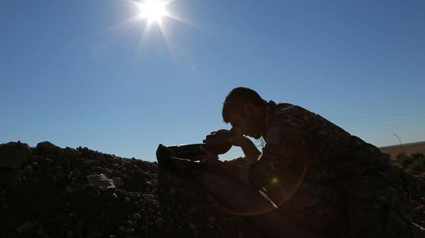 A Syria Democratic Forces fighter looks through a scope near the town of Tel al-Saman in the northern rural area of Raqqa, Syria, Nov. 17, 2016.