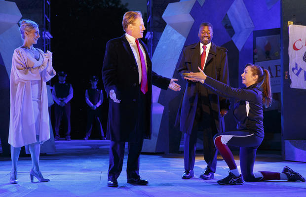 Tina Benko, left, portrays Melania Trump in the role of Caesar's wife, Calpurnia, and Gregg Henry, center left, portrays President Trump in the role of Julius Caesar during a dress rehearsal of The Public Theater's Free Shakespeare in the Park production  