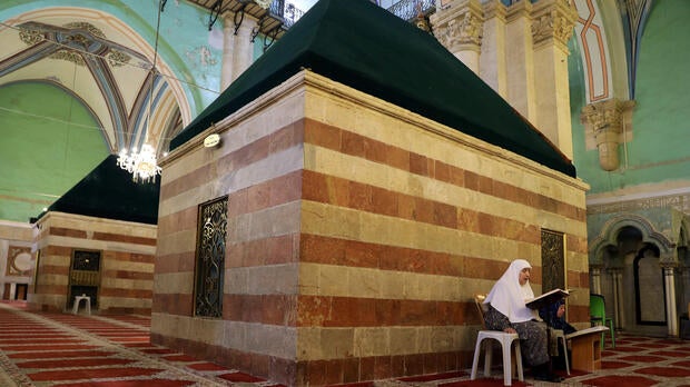 A Palestinian woman reads the Quran inside Ibrahimi Mosque, which Jews call the Tomb of the Patriarchs, in the West Bank city of Hebron July 7, 2017.