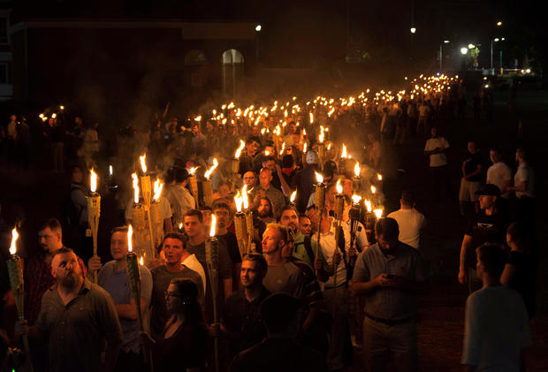 White nationalists carry torches on the grounds of the University of Virginia, on the eve of a planned "Unite The Right" rally in Charlottesville, Virginia, Aug. 11, 2017. 