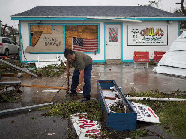 Business owner and resident clears debris from outside his shop which was hit by Hurricane Harvey in Rockport, Texas 