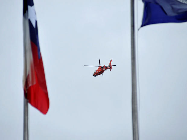 A U.S. Coast Guard helicopter flies over the downtown area after Hurricane Harvey inundated the Texas Gulf coast with rain causing widespread flooding, in Houston, Texas 