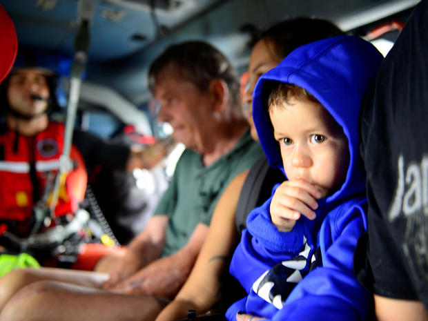 Evacuees are airlifted in a U.S. Coast Guard helicopter after flooding due to Hurricane Harvey inundated neighborhoods in Houston 