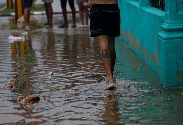 A man walks through a puddle as Hurricane Irma turns toward the Florida Keys on Saturday, in Havana 