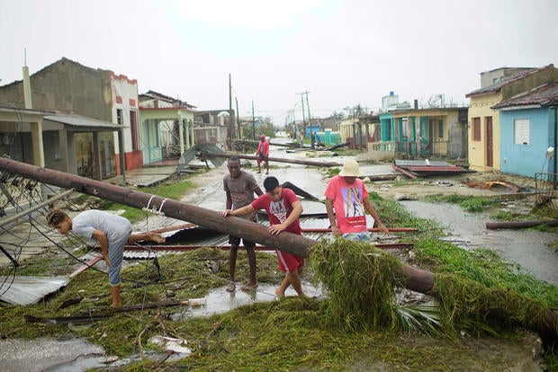 People walk on a damaged street after the passage of Hurricane Irma in Caibarien, Cuba