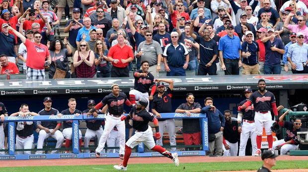 The Cleveland Indians celebrate as first baseman Carlos Santana (41) rounds third base on an attempted inside-the-park home run in the eighth inning against the Detroit Tigers at Progressive Field in Cleveland on Sept. 13, 2017. Santana was tagged out at