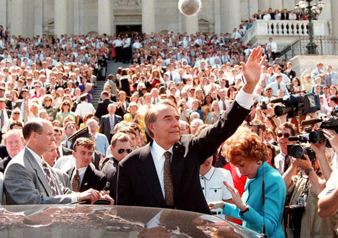 Retiring U.S. Sen. Bob Dole, R-Kansas, is surrounded by staffers and well-wishers as he prepares to leave the U.S. Capitol in Washington June 11, 1996. Dole ended his 35-year career in the Senate in order to devote his full attention to his presidential c 