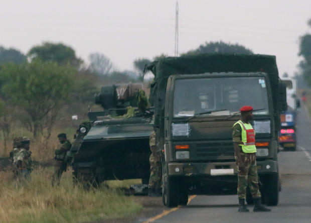 Soldiers stand beside military vehicles just outside Harare,Zimbabwe 