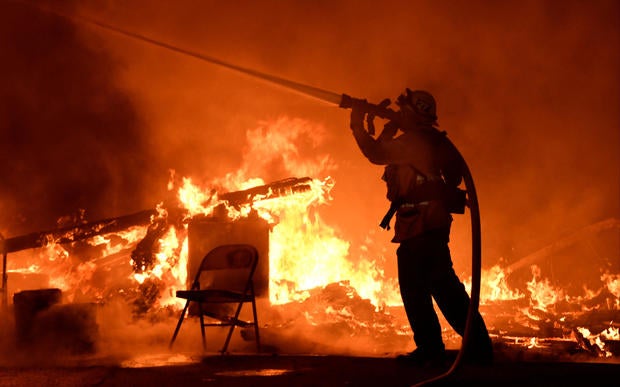 Firefighters battle flames from a Santa Ana wind-driven brush fire called the Thomas Fire in Santa Paula, California, Dec. 4, 2017.